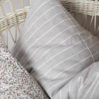 Stribet pude aflang mixet med blomstret pude i kurvestol